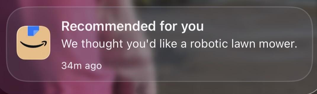 A notification from Amazon recommending a robotic lawn mower, displayed with a company logo, timestamped 34 minutes ago.